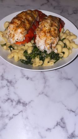Broiled lobster and pasta with spinach