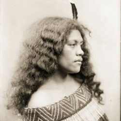 Head and shoulders portrait of Tini Ratana of Parikino, Wanganui River. She is wearing a piupiu  ...