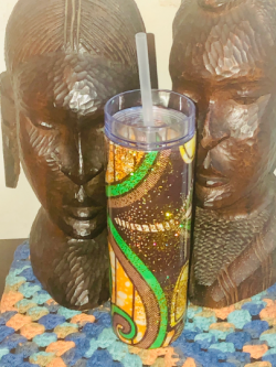 The acrylic tumbler is made with Afrocentric Fabric and sealed with expoxy